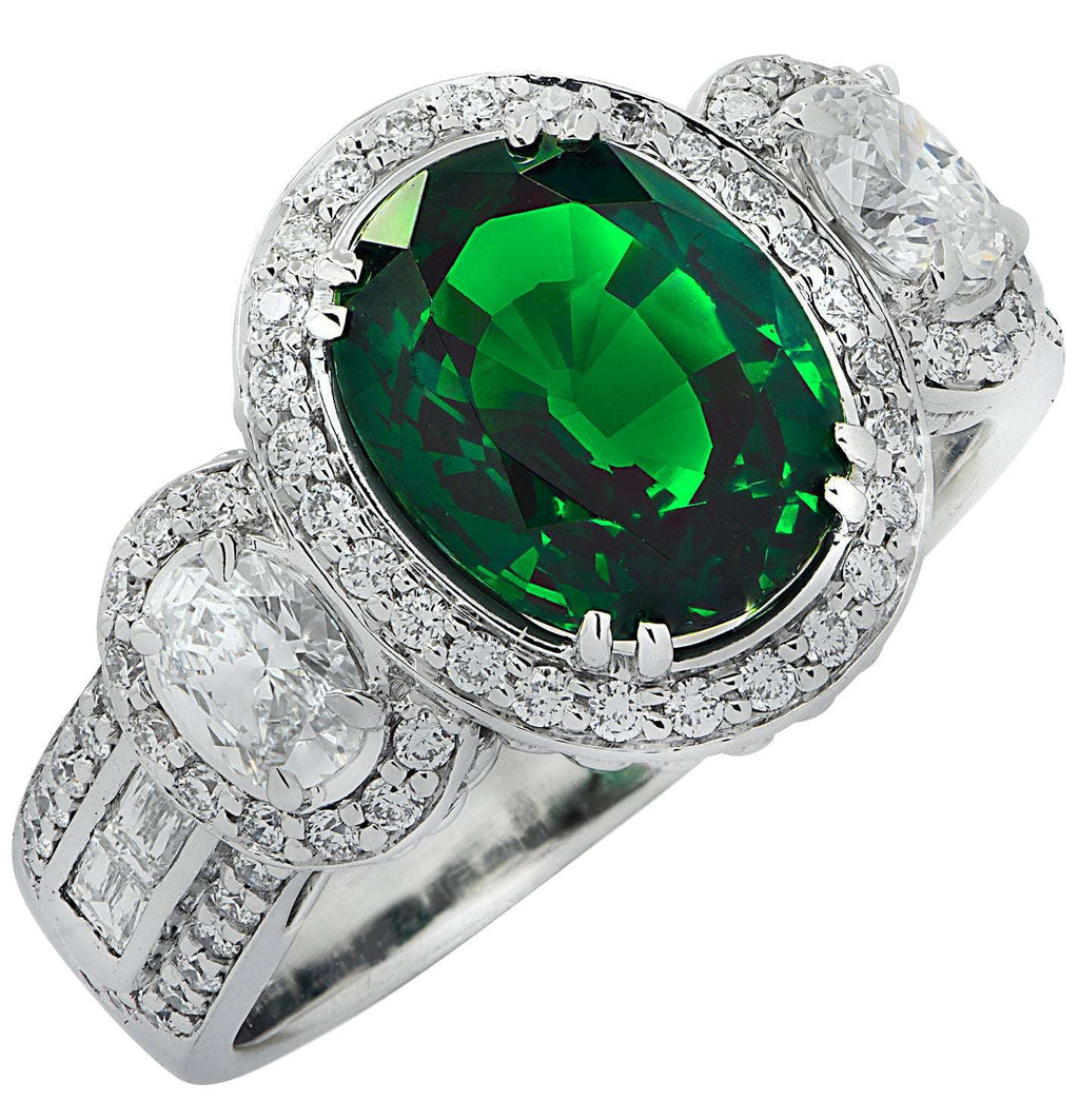 Vivid Diamonds 3.38Ct Oval Cut Tsavorite & Diamond Halo Ring in 18K White Gold featuring a vibrant green Tsavorite centerpiece surrounded by sparkling diamonds, exuding luxury.