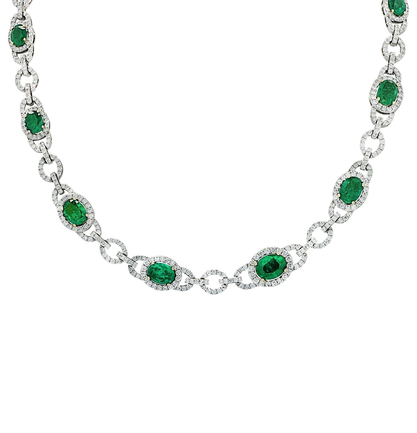 18K White Gold Diamond and Emerald Necklace featuring 12.28 carats of emeralds and 7.92 carats of diamonds, crafted by Vivid Diamonds. A luxurious piece showcasing a stunning design with vibrant emeralds surrounded by sparkling diamonds.
