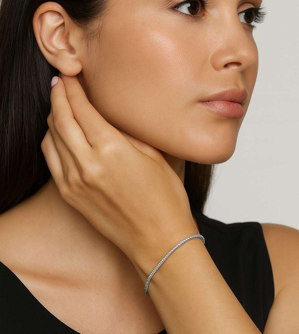 Elegantly showcasing the Stunning 14K White Gold Diamond Bracelet by Vivid Diamonds, worn on a model's wrist. This piece features 93 brilliant diamonds totaling 2.30 carats, exuding luxury and sophistication.