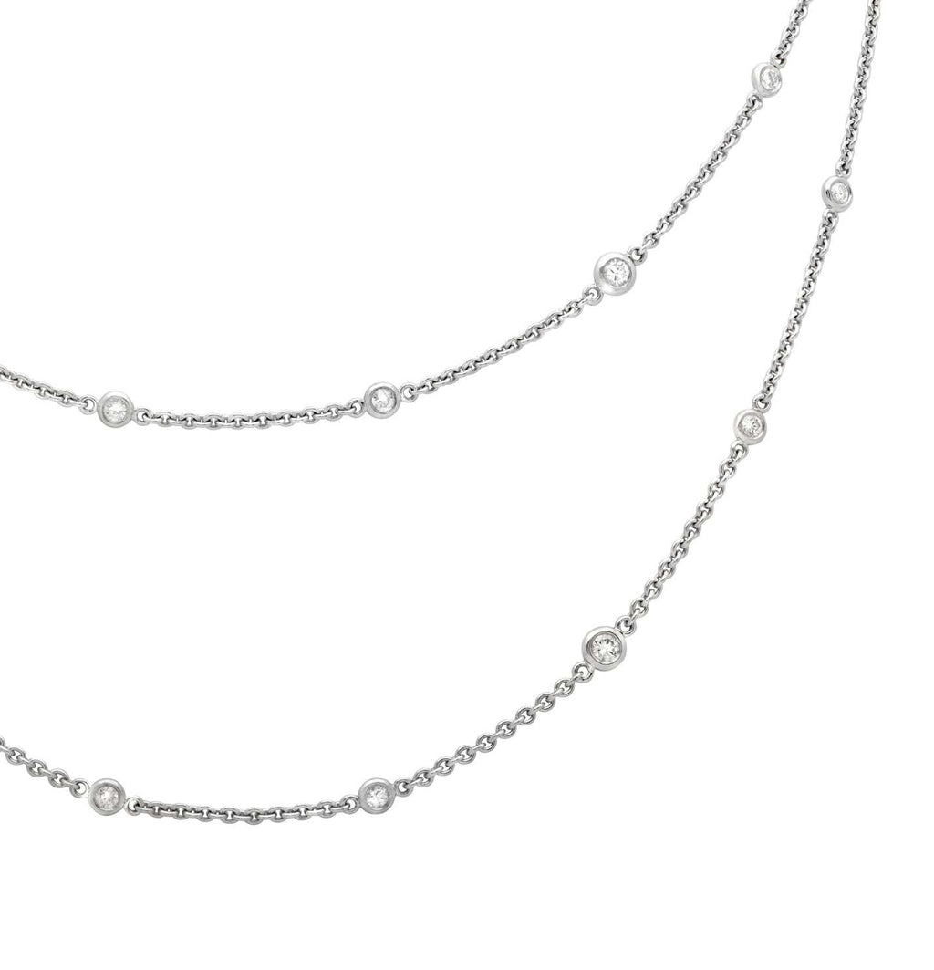 Elegant 18K White Gold Diamond Necklace with 2.2ct Round Brilliant Diamonds by Vivid Diamonds displayed gracefully against a white background, showcasing the necklace's exquisite design and diamond arrangement.