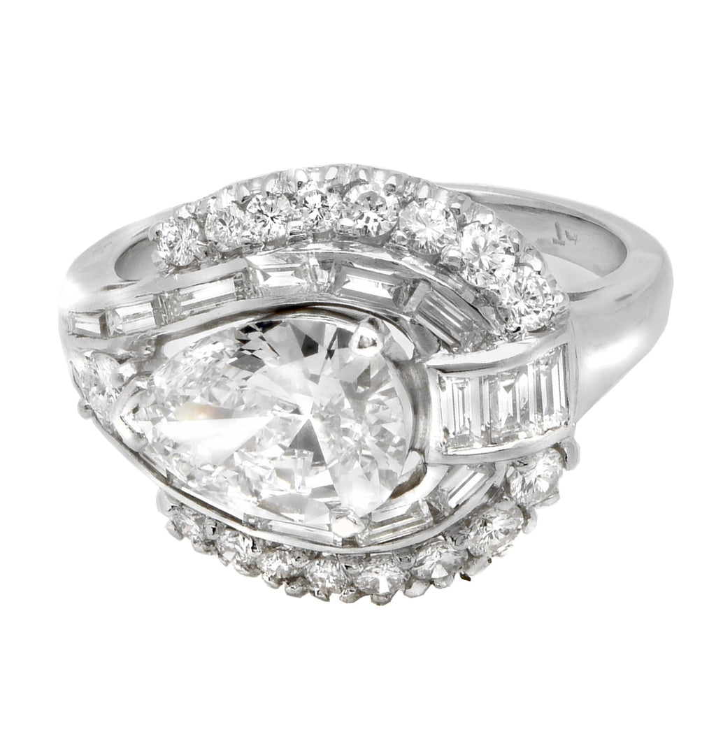 Elegant 1.27ct Platinum Pear Cut Diamond Engagement Ring with VS1 Clarity and E Color, featuring a prominent pear-shaped center stone encircled by brilliant round and baguette diamonds for a timeless look.